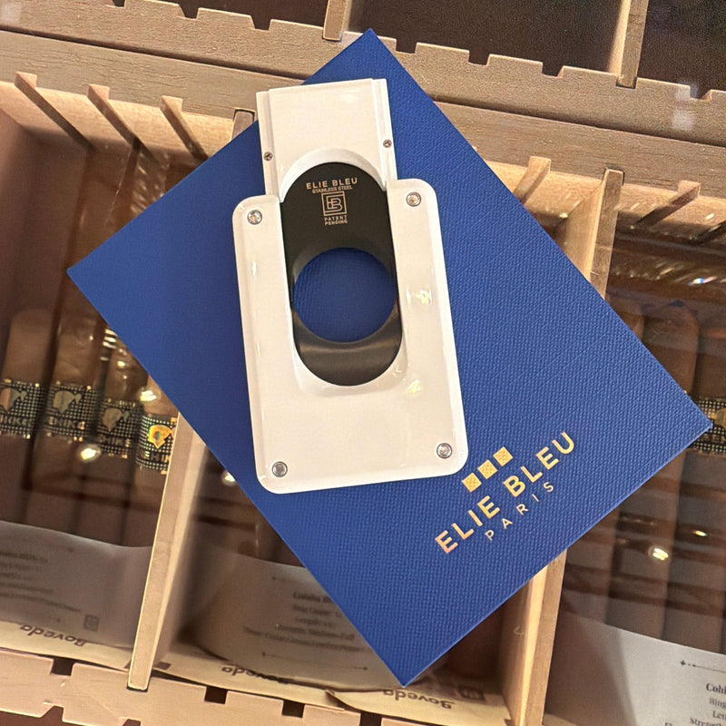 HAMILTON Elie Bleu C-4 cigar cutter in white with a black ion-plated blade resting on a blue branded gift box