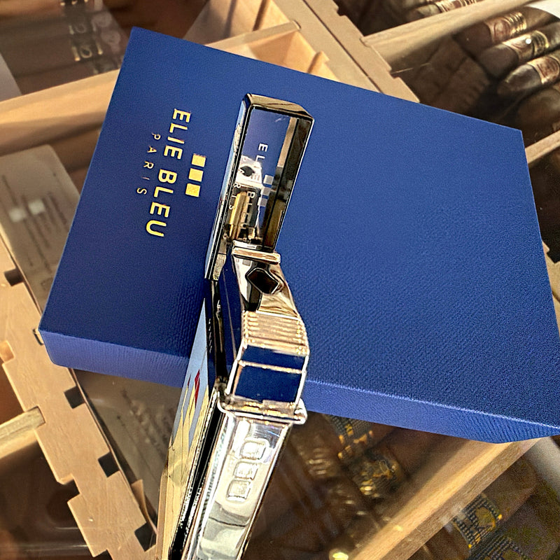 HAMILTON ELIE BLUE Casa Cubana limited edition black ion plated lighter resting on its blue presentation box