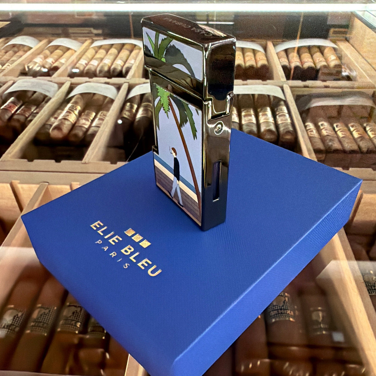 HAMILTON ELIE BLUE Limited Edition Casa Cubana lighter with black ion plating and a tropical beach scene design.