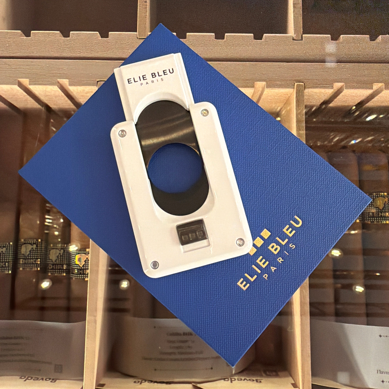 HAMILTON ELIE BLEU C-4 cigar cutter in white with a black ion-plated blade, displayed on a blue textured box.