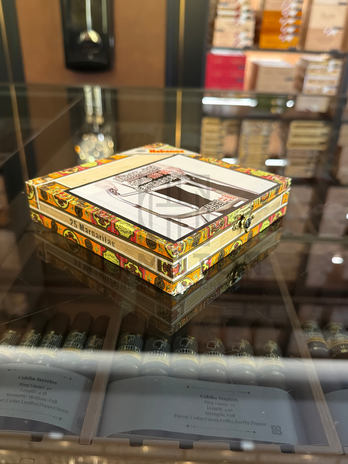 HAMILTON Punch 25s Margaritas 2007 cigar box with decorative vintage label on a glass display shelf