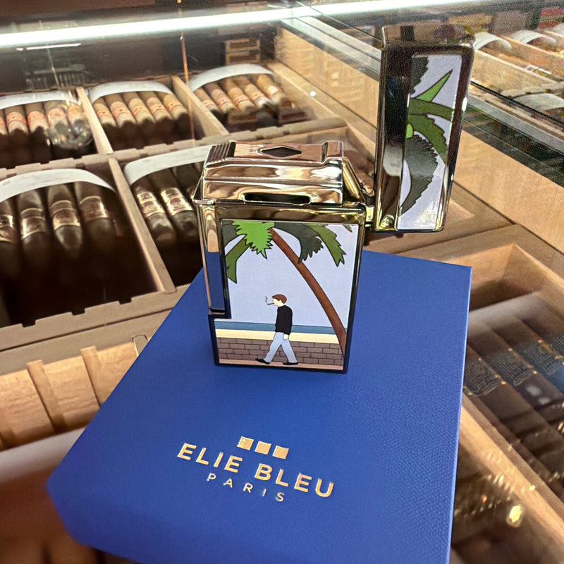 HAMILTON ELIE BLUE Limited Edition Casa Cubana lighter with black ion plating and palm tree beach scene illustration.