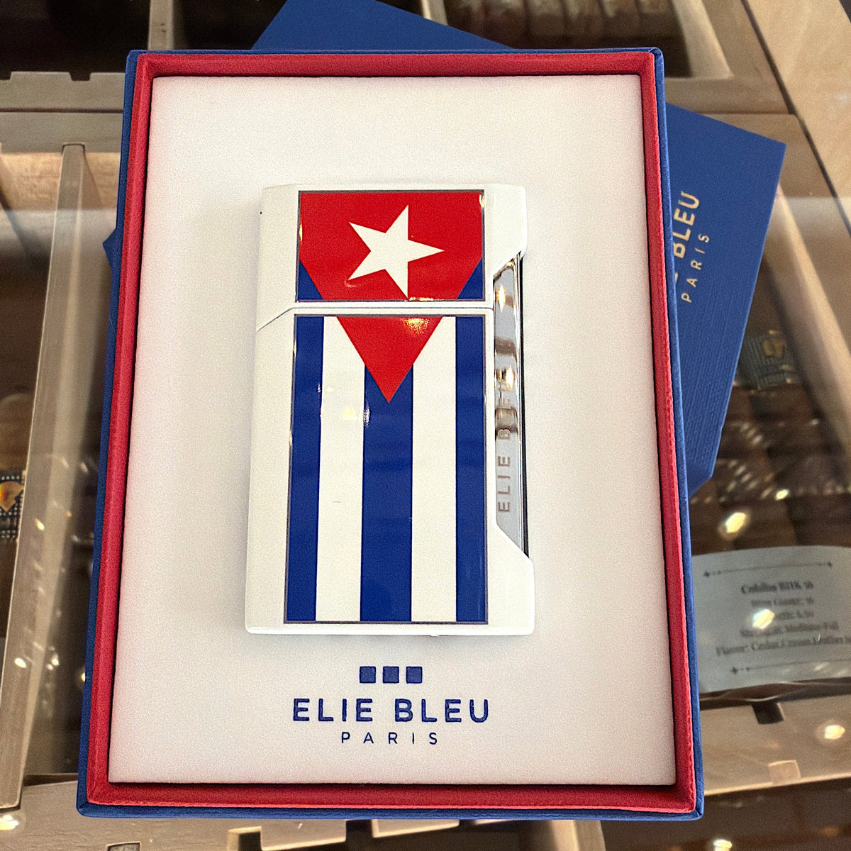 HAMILTON ELIE BLUE Cuban flag J-12 flat flame lighter in a white presentation box with blue trim.